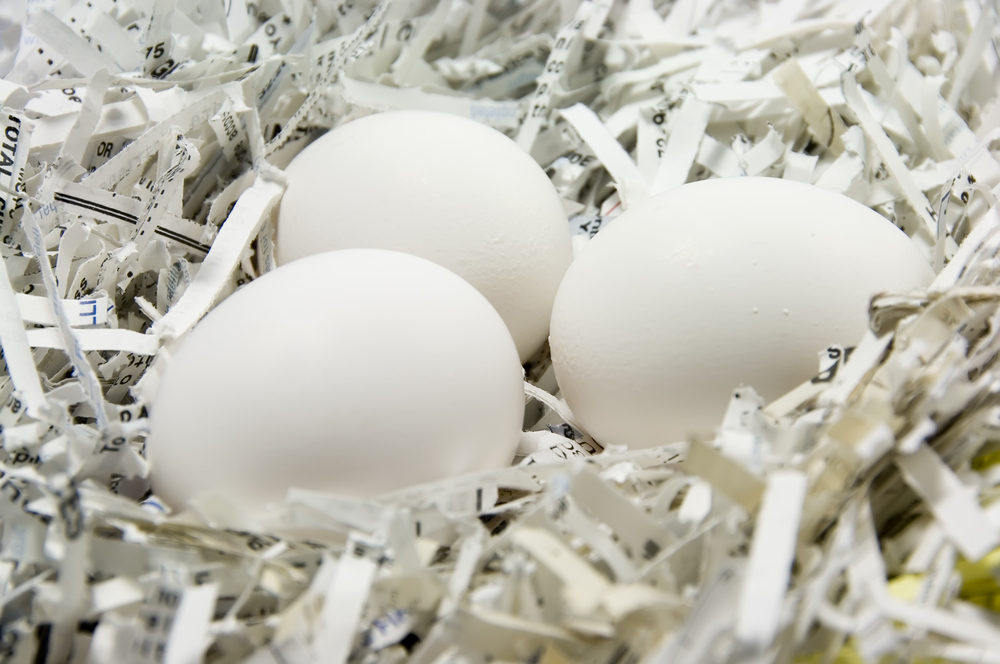 Three eggs in a nest of shredded paper